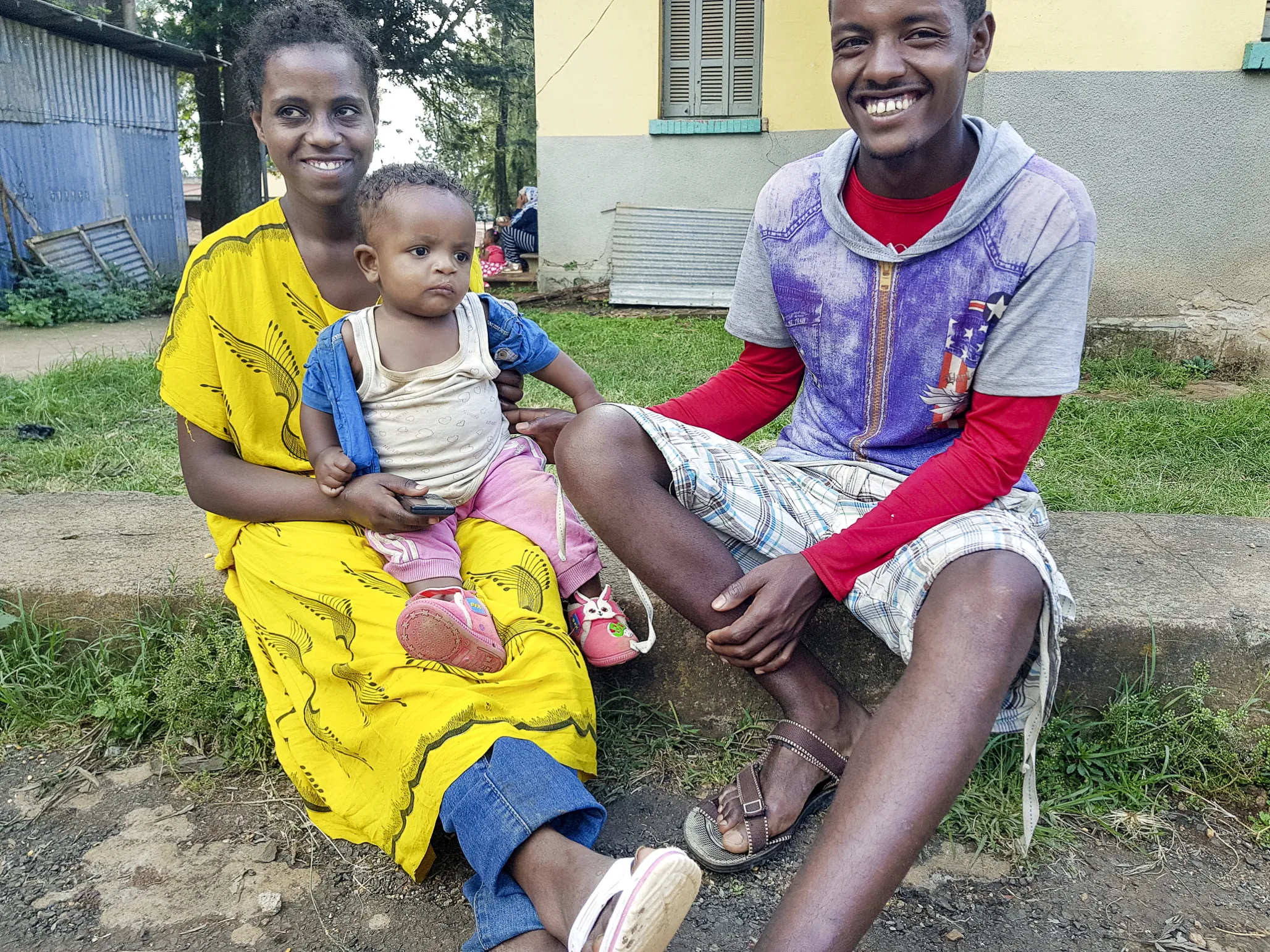 Tesfasihu and Yusuf pose for a photo with their 2-year-old son, Ashenafi, whose name means “the winner.”