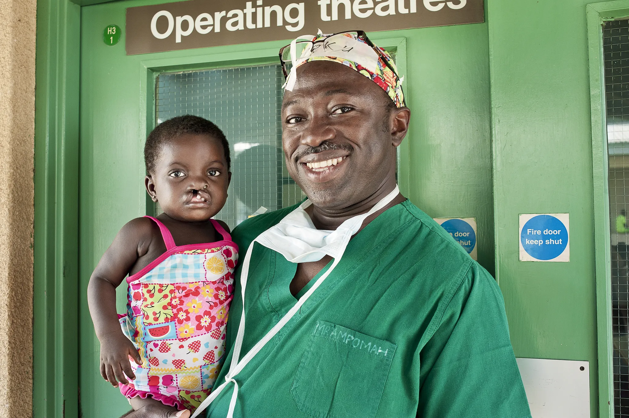 Dr. Opoku Ampomah smiles with a patient during a surgical program in Ho, Ghana.