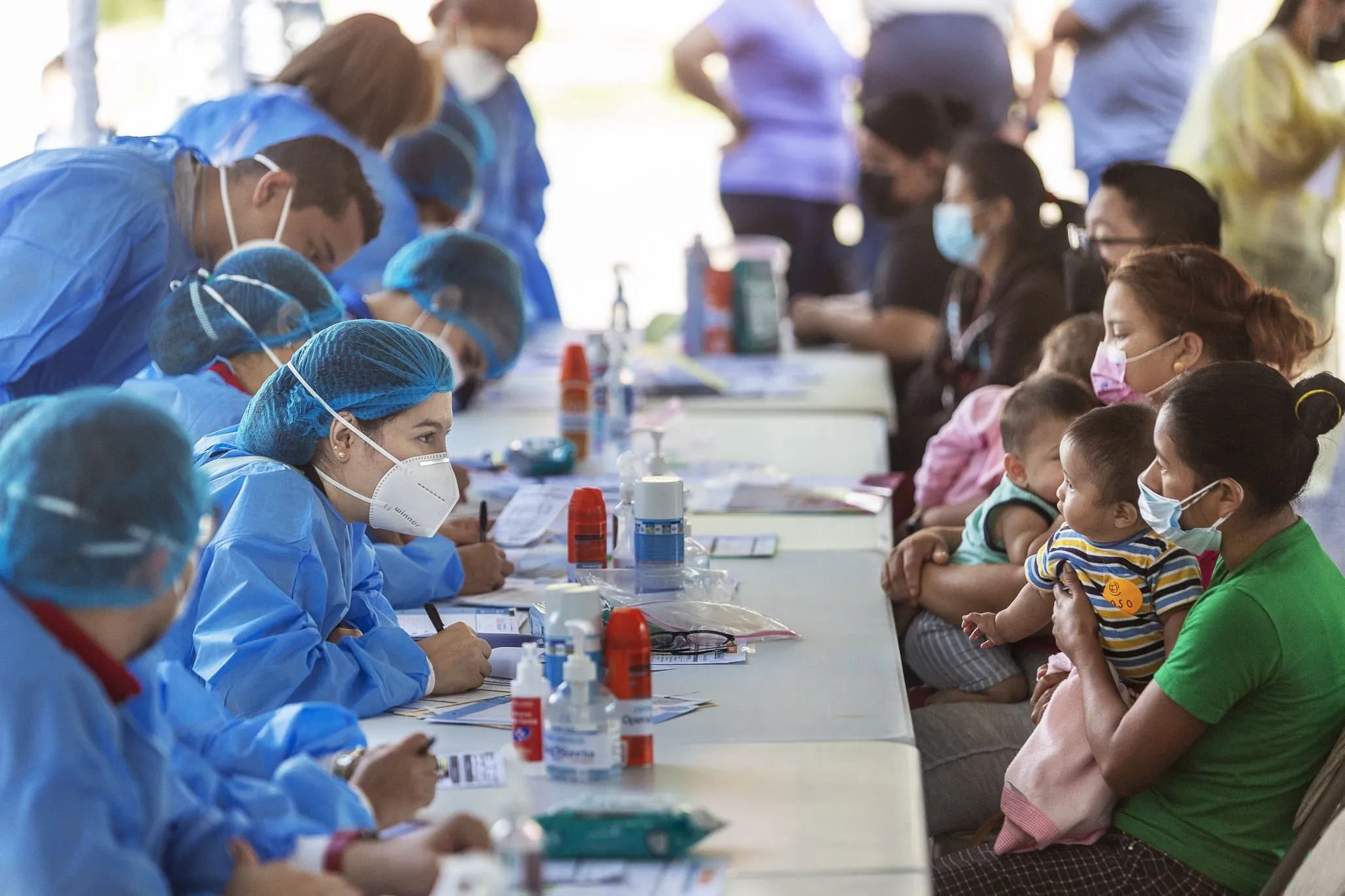 Families speak to volunteers during screening day in Tegucigalpa.