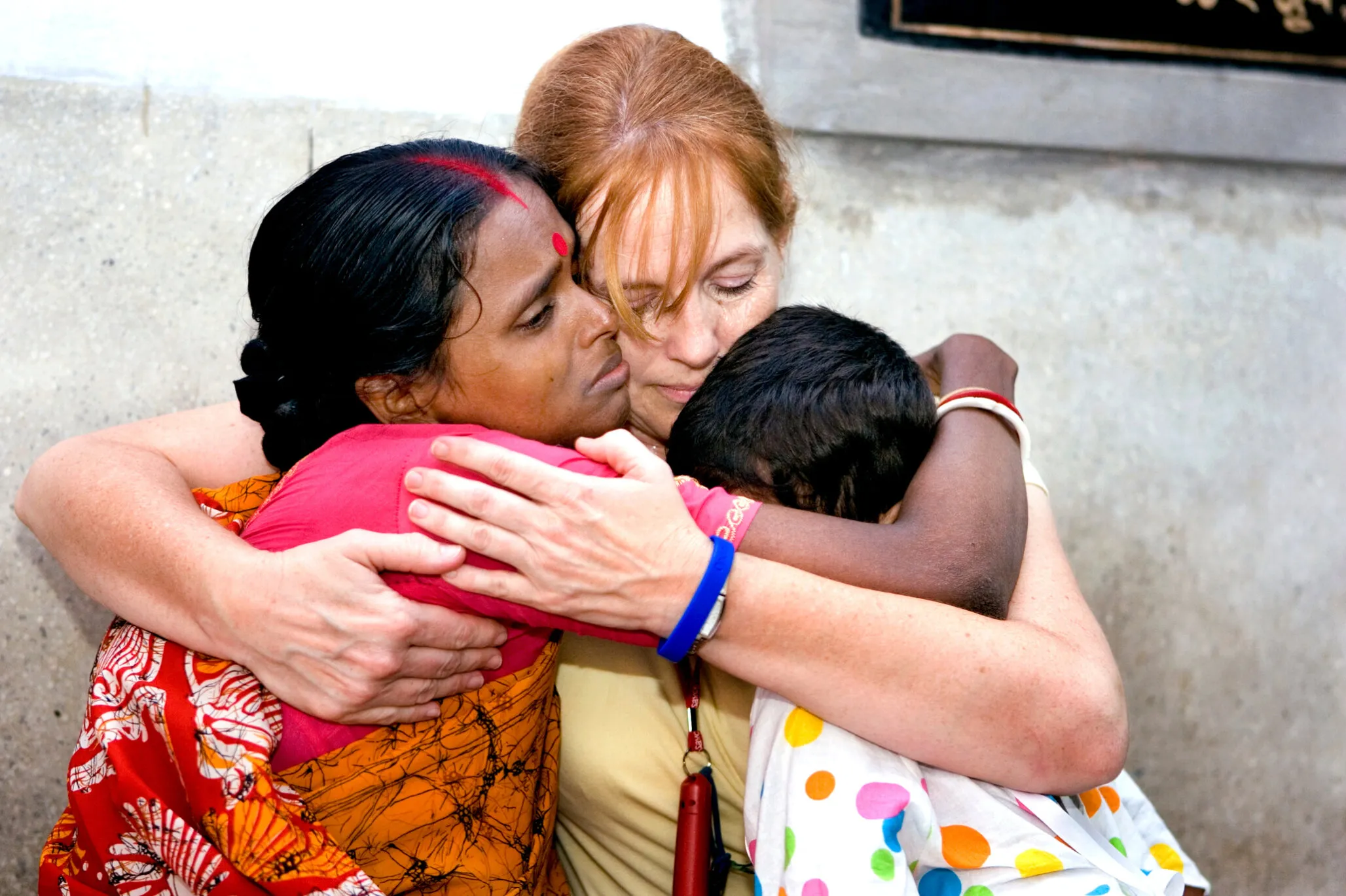 Rikta, her mother and child life specialist Shannon Case of the U.S. embrace each other before her surgery.