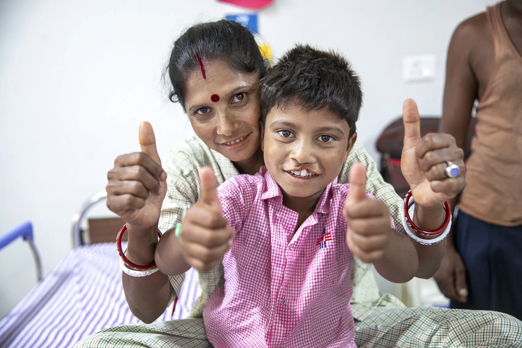 Bipul with his mother, Nioti, as they wait for his surgery to repair his cleft lip.