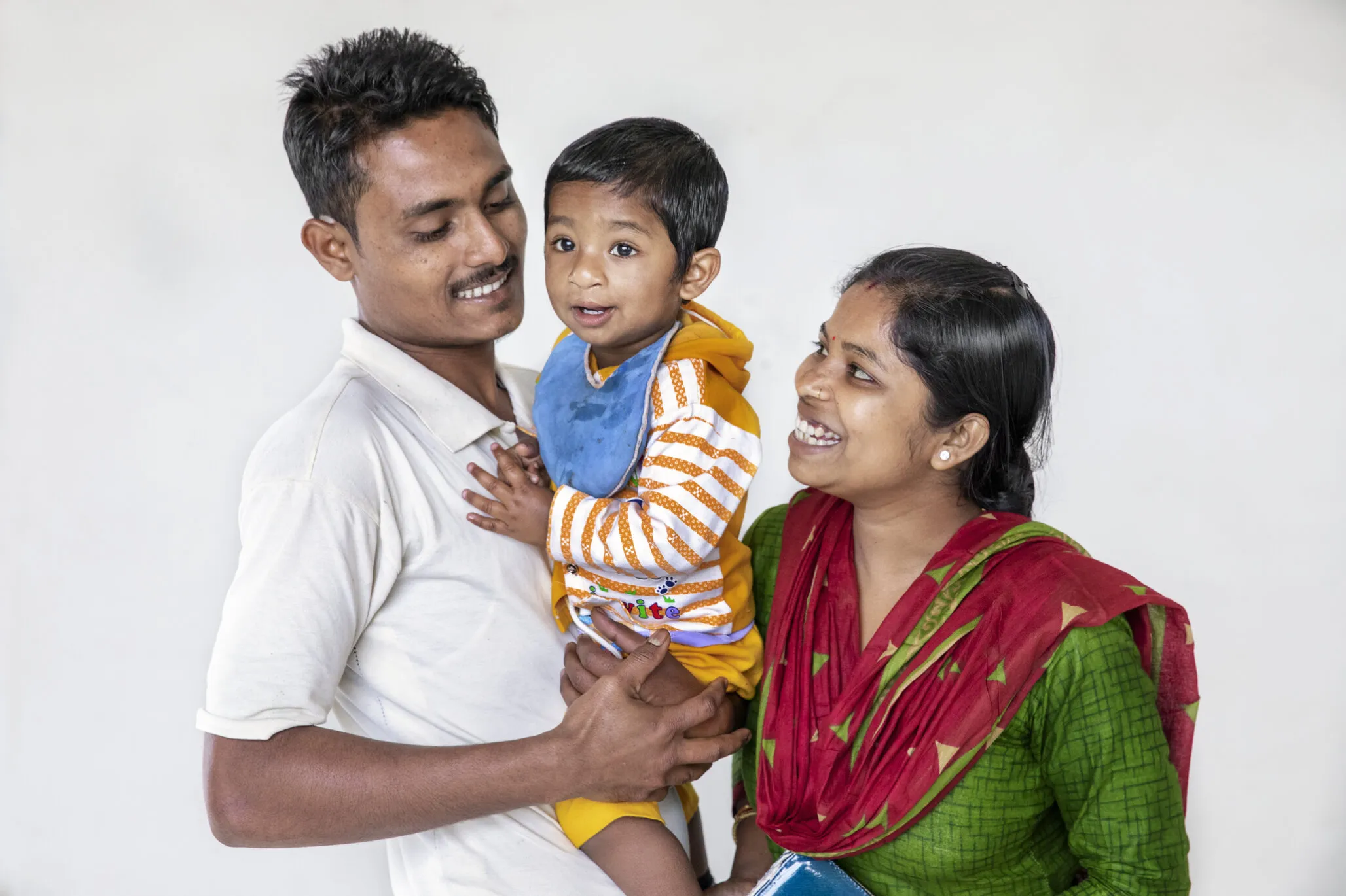 A patient smiles with his parents.