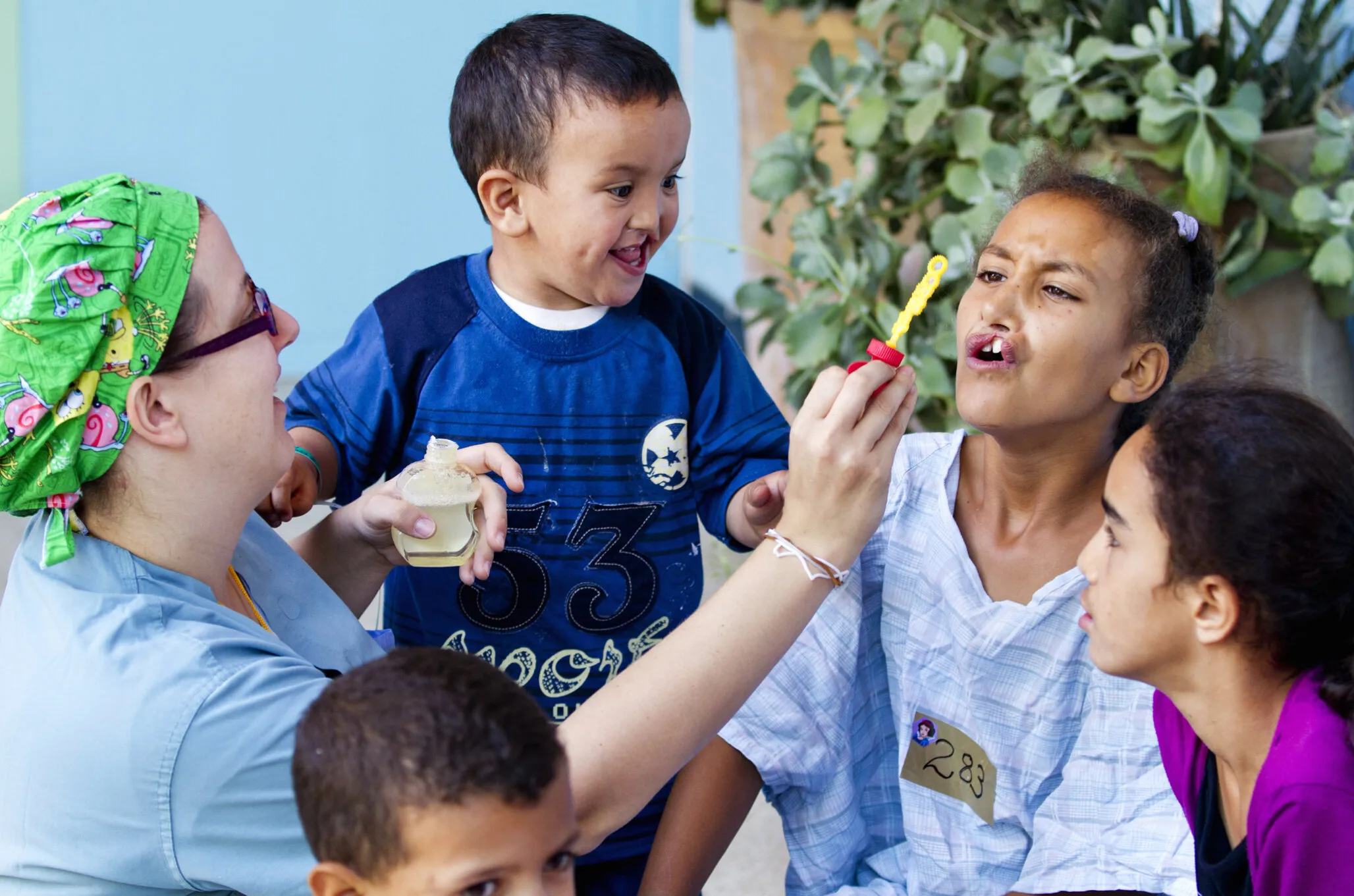 Volunteer psychosocial care provider Jen Burton Liang of Canada shares a special moment with a group of patients during a 2011 surgical program in Morocco.