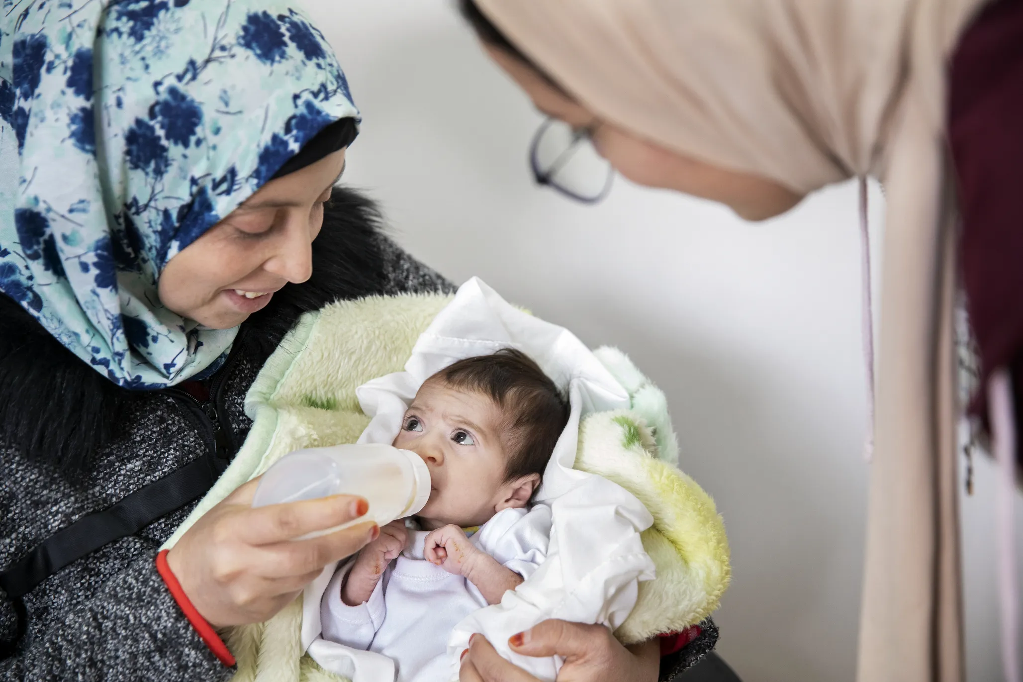 For perhaps the first time, Fatima watches as Janat drinks milk without choking thanks to her daughter’s new feeding plate.