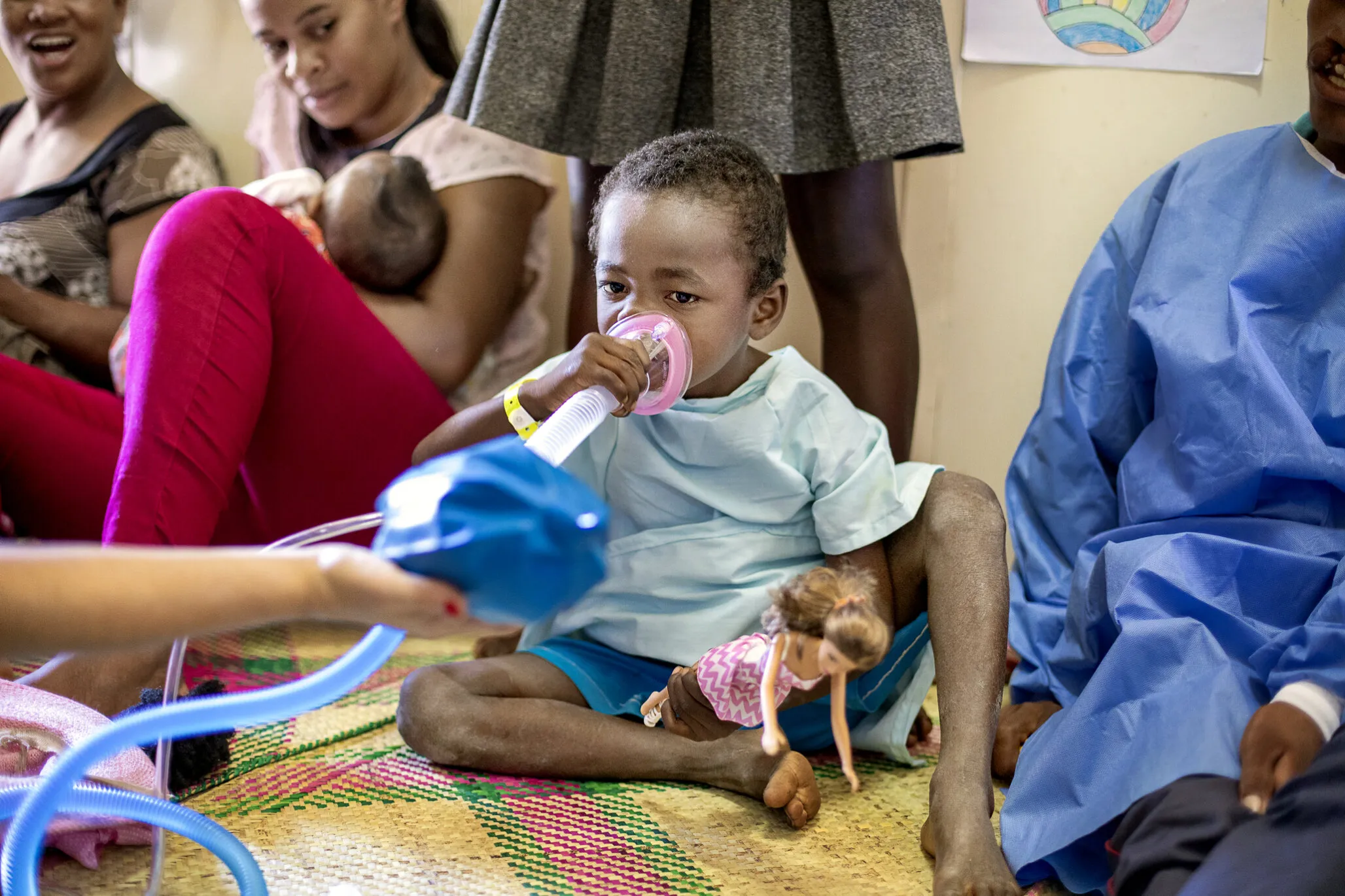 A patient plays with an anesthesia mask before surgery during an Operation Smile surgical program in Madagascar.