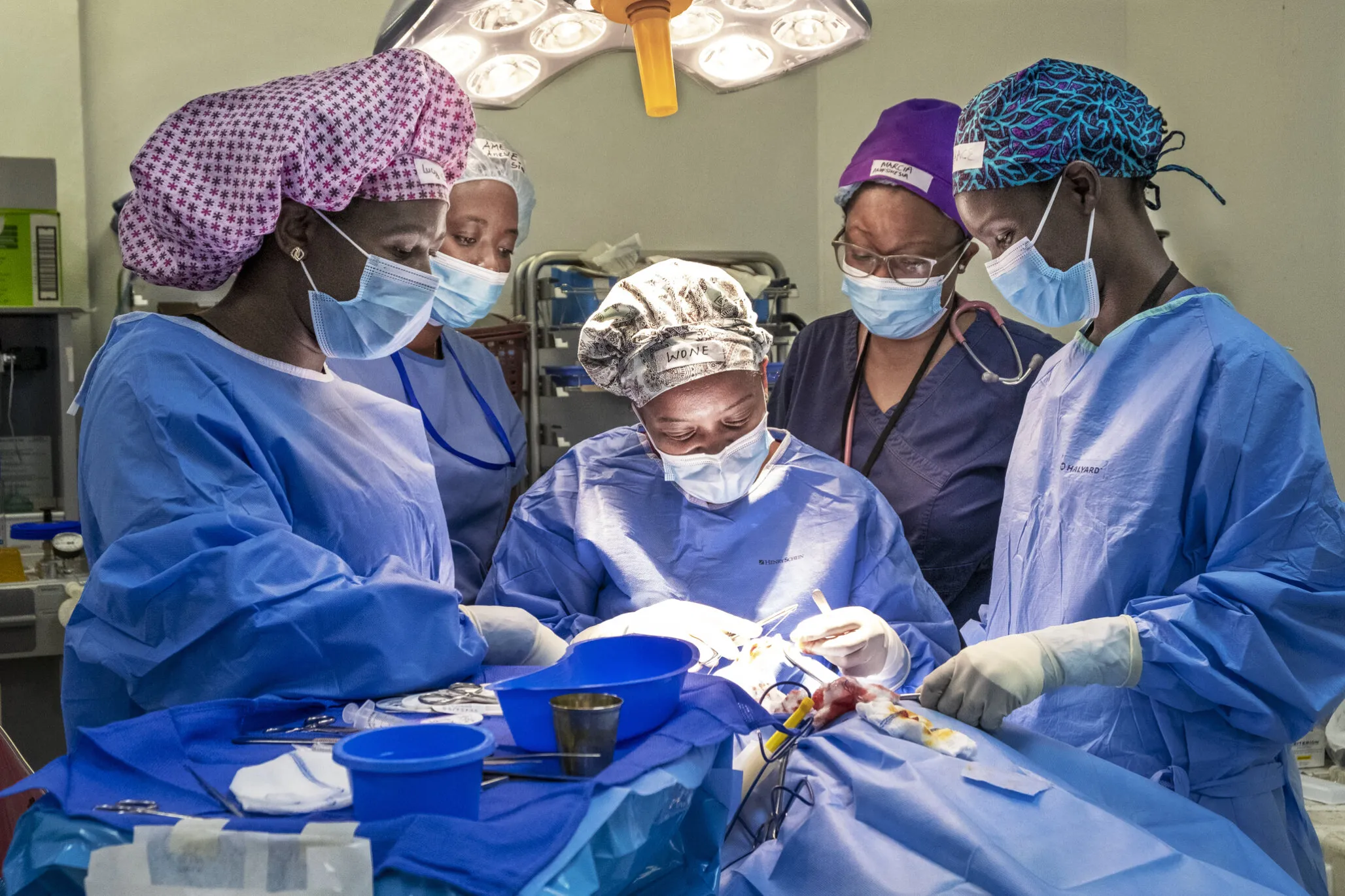 In the operating room during a Women in Medicine surgical program, cleft surgeon Dr. Wone Banda, center; surgical scrub personnel, Lucy Dodoli, left; pre- and post-operative nurse Grace Chirwa, right; and anesthesiologist Dr. Amelie Kamagaju, back left, working together as an all-female surgical team