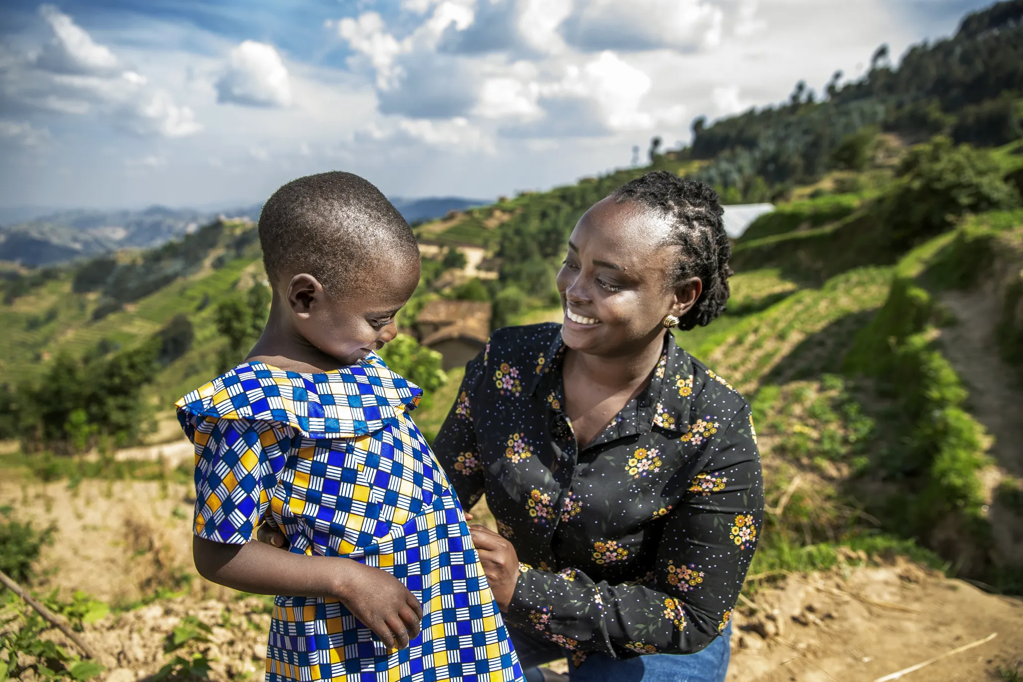 Dr. Francoise Mukagaju smiles at the camera with one of her patients, Valentine.