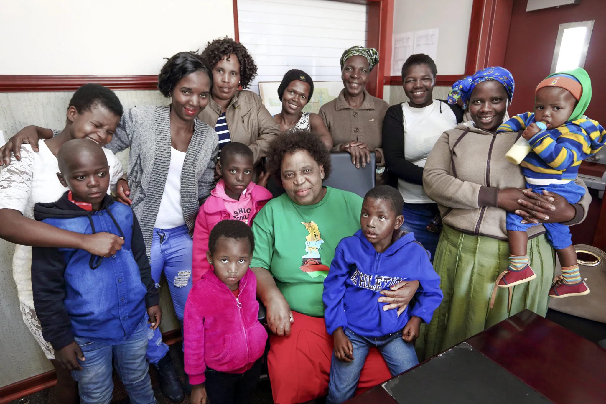 Nurse Funeke Cele poses with patients and family members in South Africa.