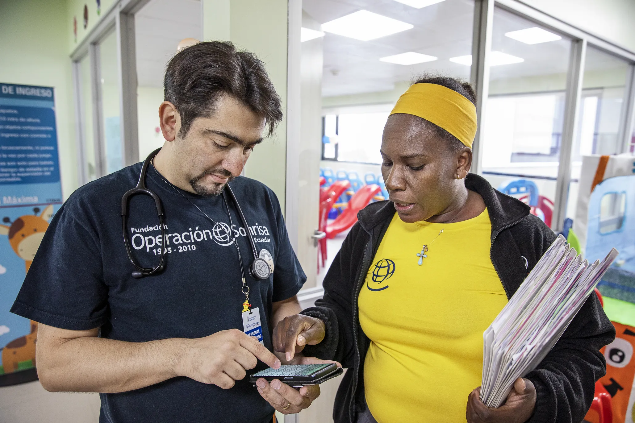 Clinical coordinator Homaire Caicedo of Ecuador, right, and volunteer pediatrician Dr. Mauricio Guerra of Ecuador, evaluate the surgical schedule during a 2019 surgical program in Quito.