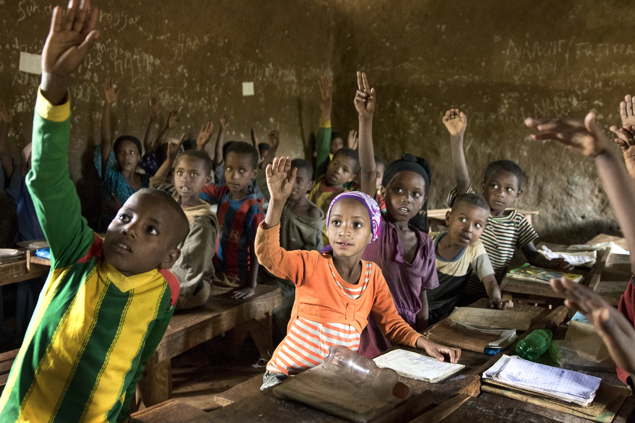 Nazifa raises her hand in school, after surgery.