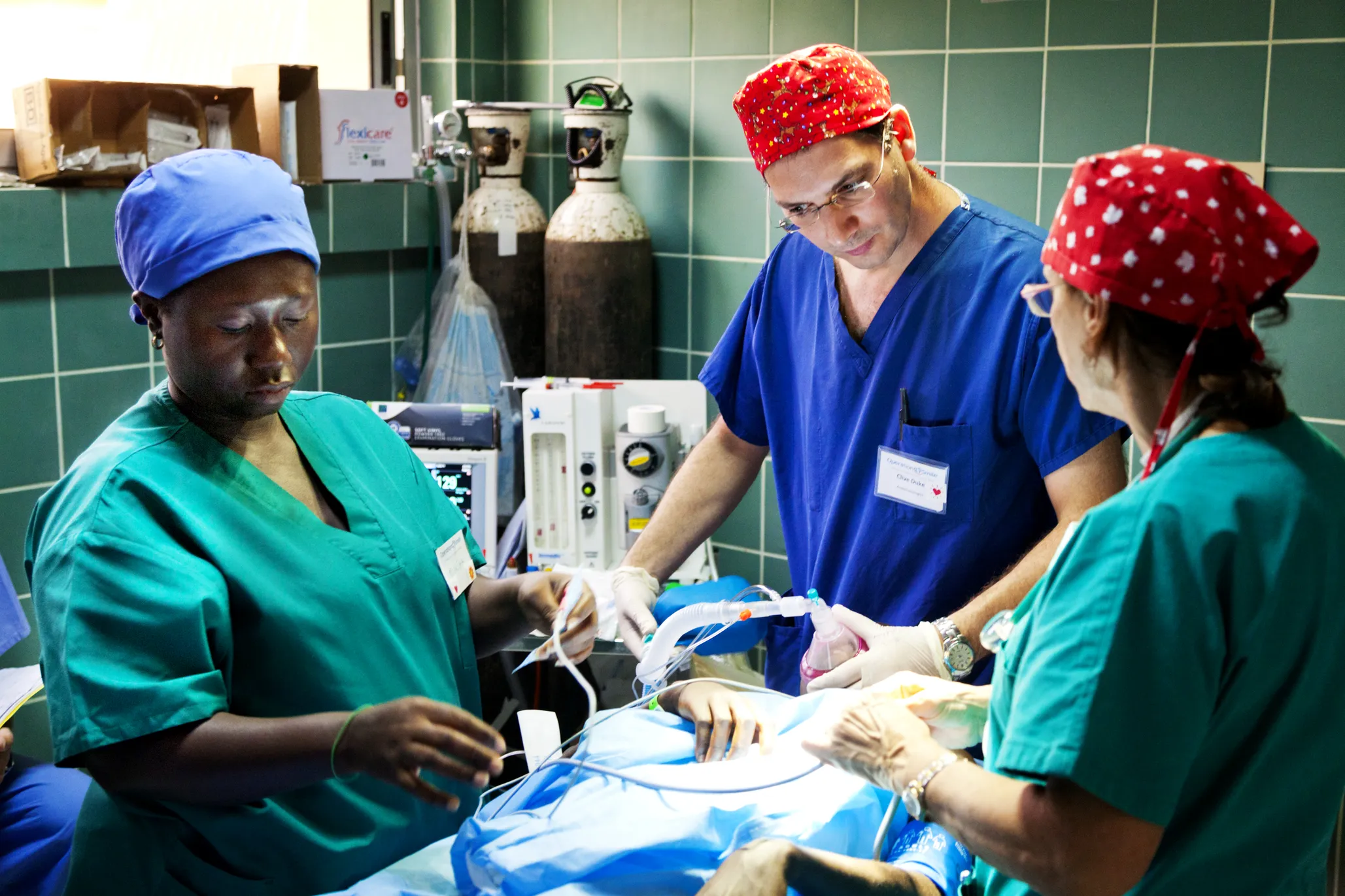 Volunteers treat a patient during a surgical program in Ghana.