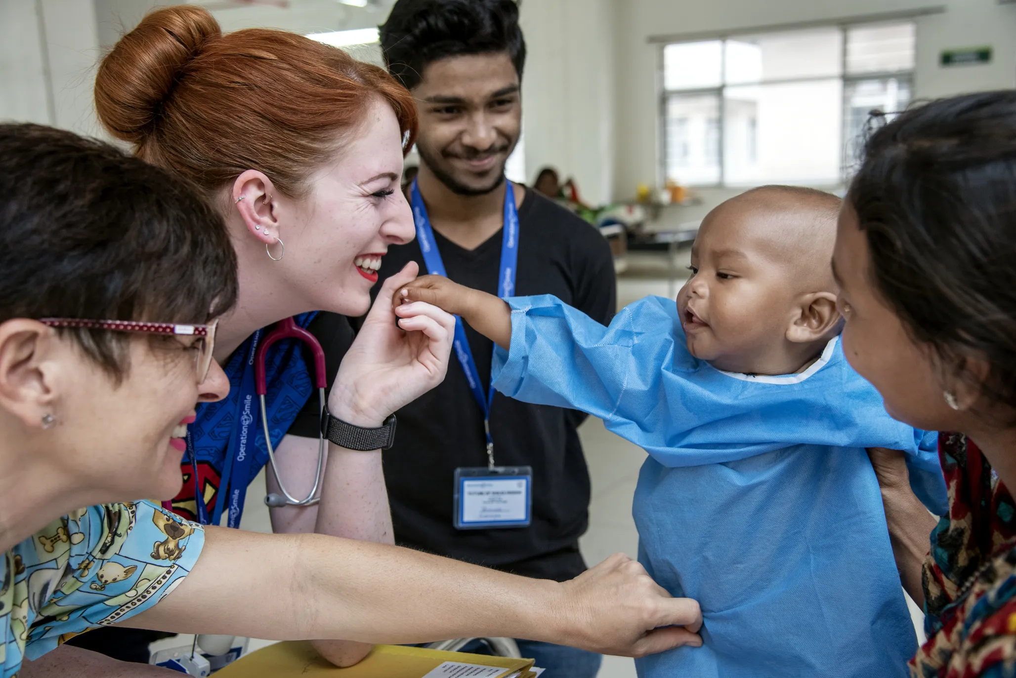 Volunteer nurses Lora Edwards of the UK, left, Karen Allen of Australia 10-month-old Ezhan during Operation Smile India's February 2020 surgical program in Durgapur.