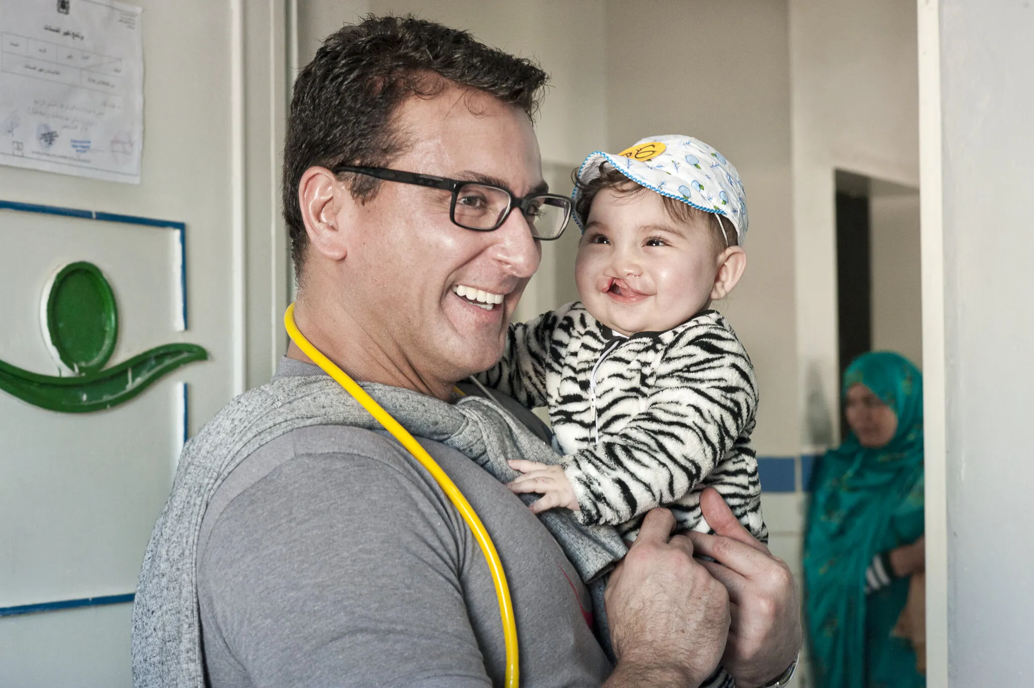 Volunteer anesthesiologist Dr. Marcello Texiera of Brazil shares a smile with Rania.