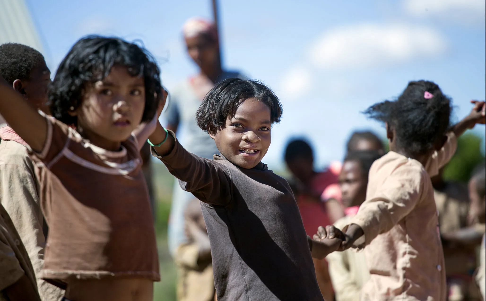 Clara, with her new smile, plays with friends.