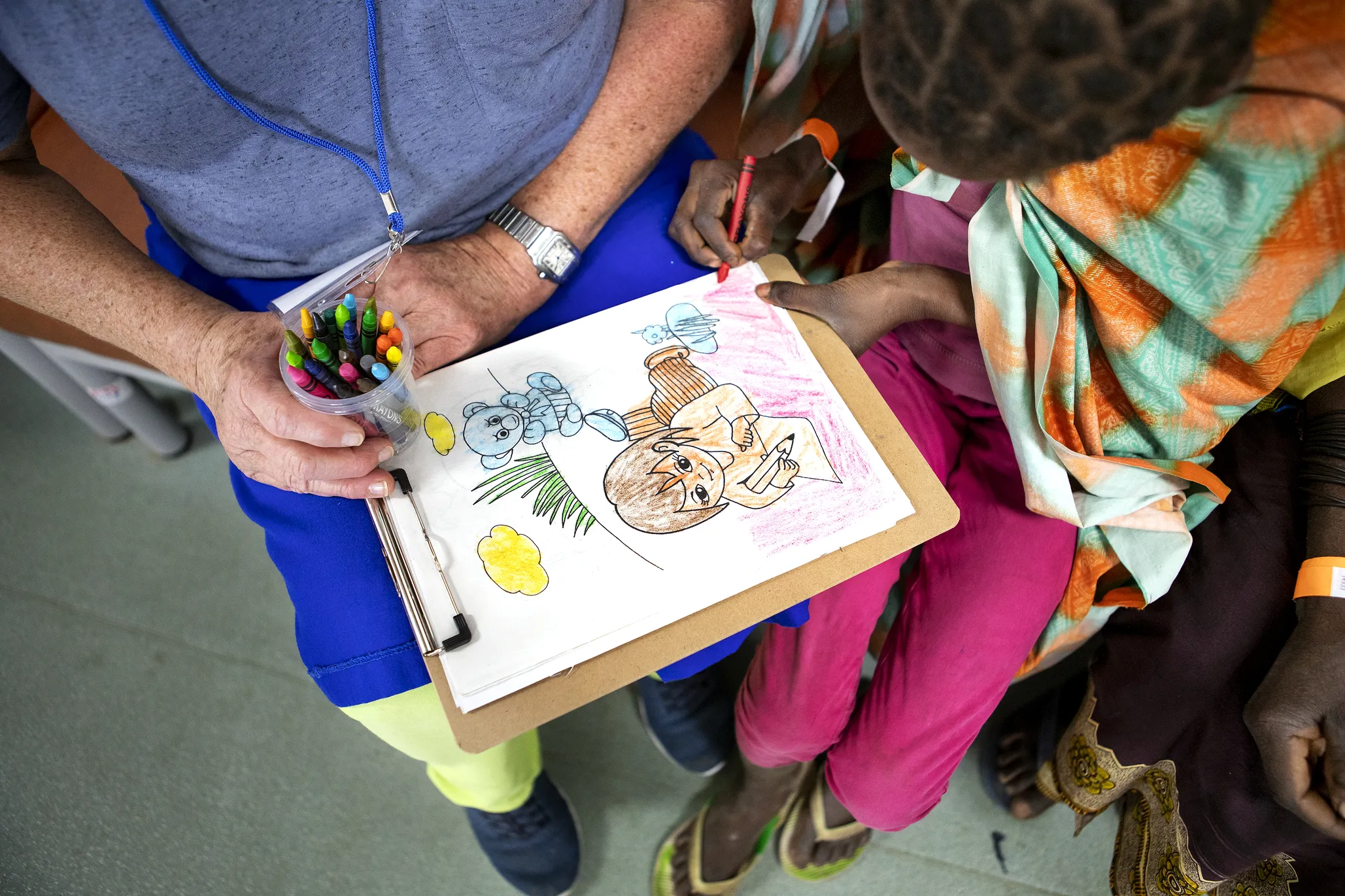 Noemia engages in therapeutic play with a volunteer.