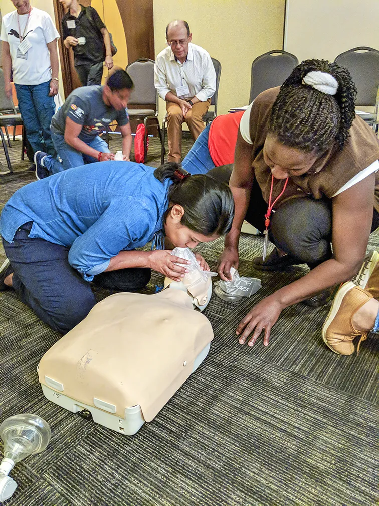 AHA instructor and Operation Smile clinical coordinator Homaire Caicedo of Ecuador, right, supervises Panamanian nurse Isis Campos during a BLS training session.