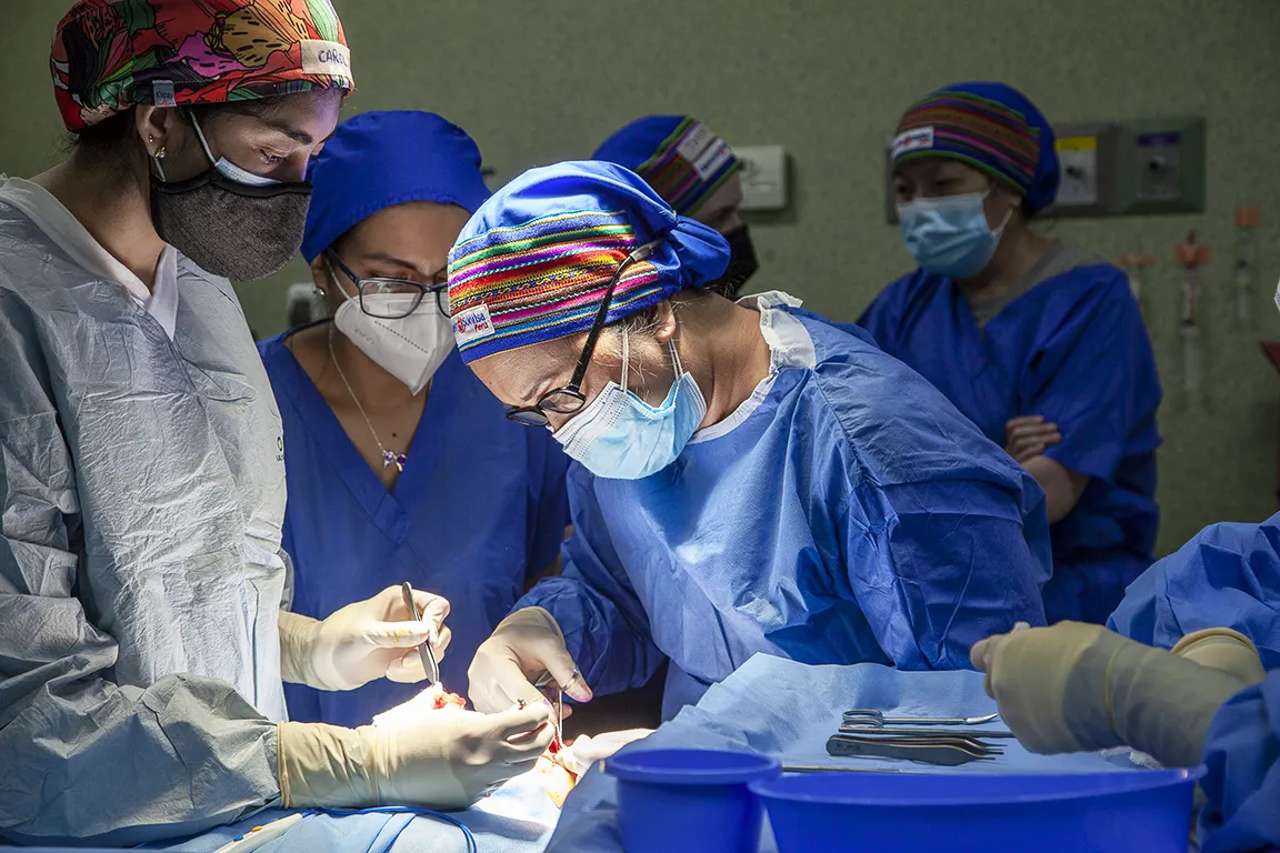 Dr. Lora Mae De Guzman, cleft surgeon of the Philippines, center, performs surgery during Operation Smile's June 2022 Women in Medicine surgical program in Lima, Peru.