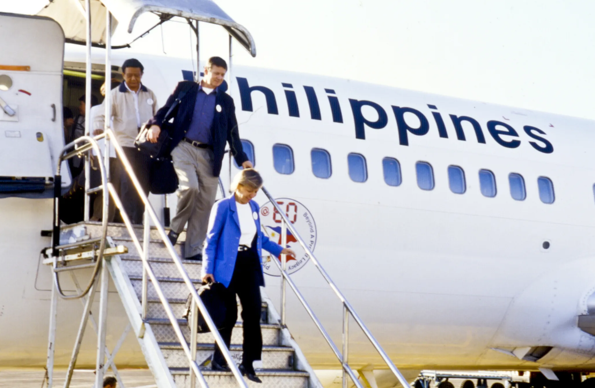 Operation Smile's co-founders Dr. Bill and Kathy Magee disembark from a plane after landing Naga, Philippines.