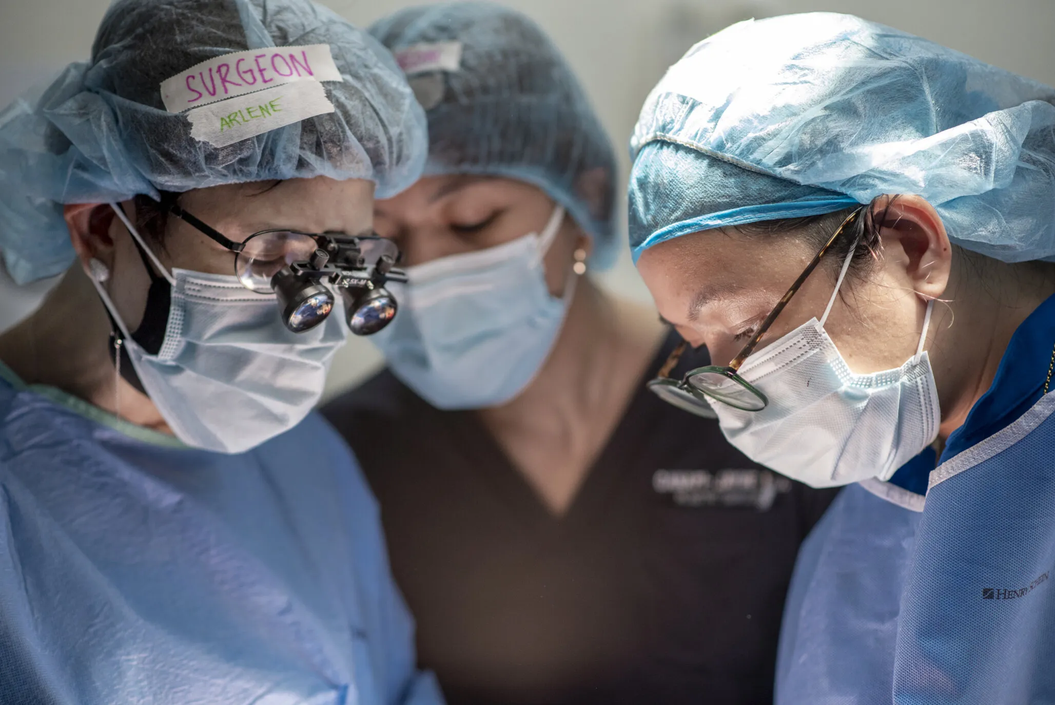 Volunteers treat a patient during the Women in Medicine surgical program in 2022.