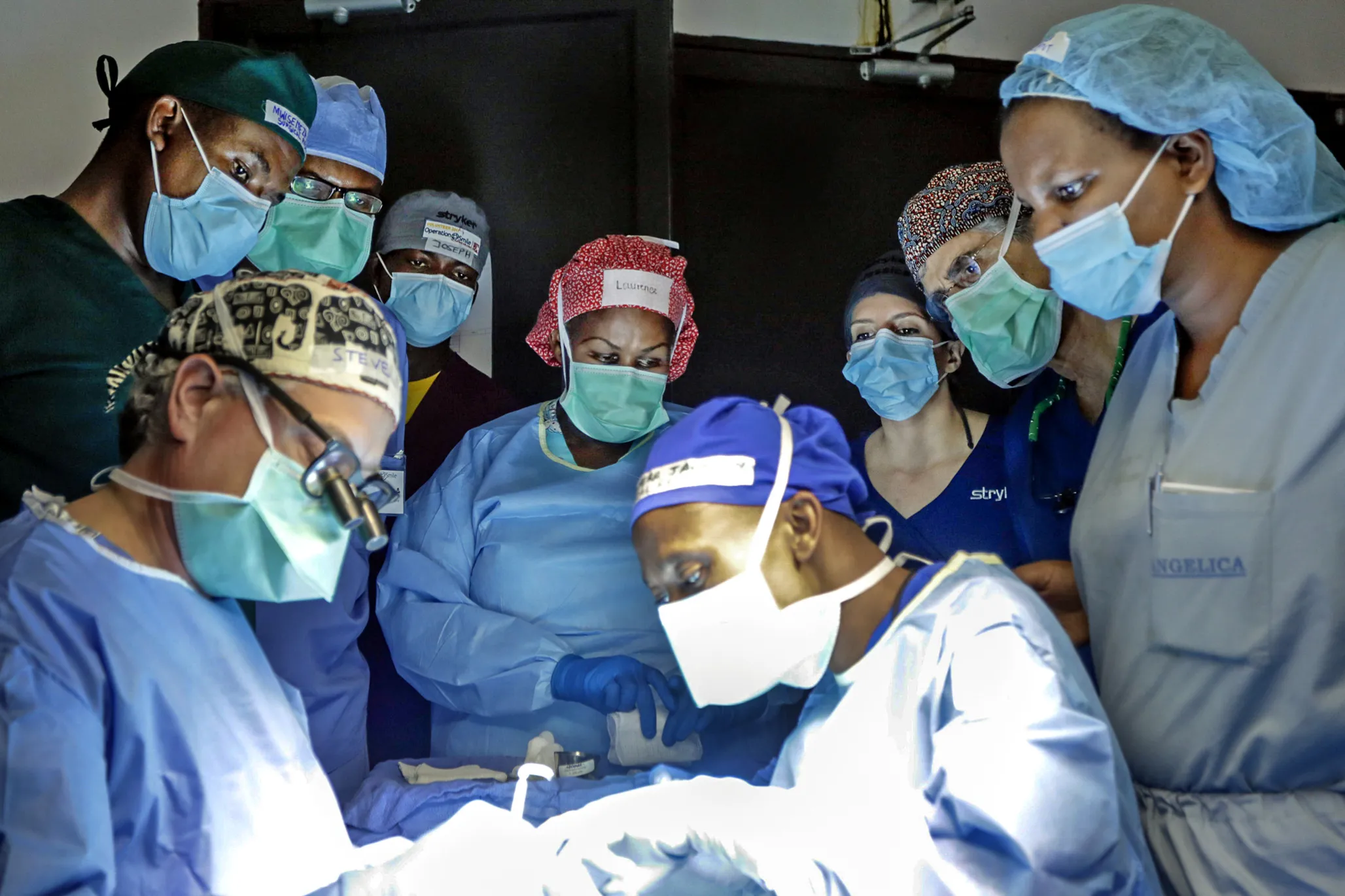 Rwandan surgical residents observe as a volunteer cleft surgeon performs surgery during Operations Smile’s April 2019 surgical training rotation at Rwinkwavu District Hospital in Rwinkwavu, Rwanda.