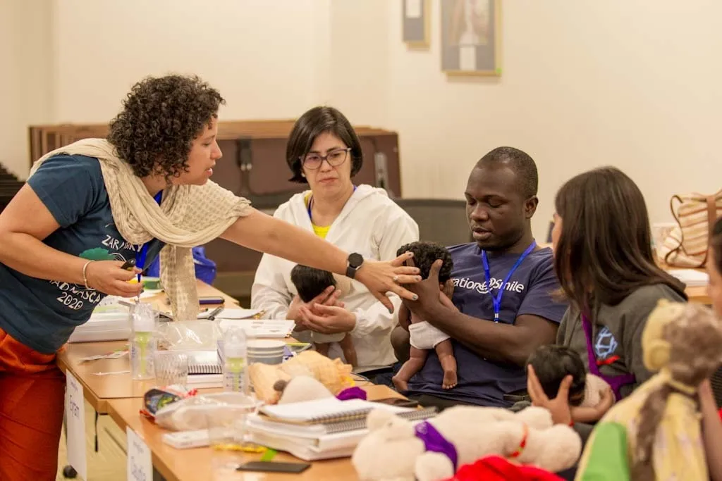 Tereza provides instruction around breastfeeding to Eyram during the 2023 Comprehensive Care Conference.