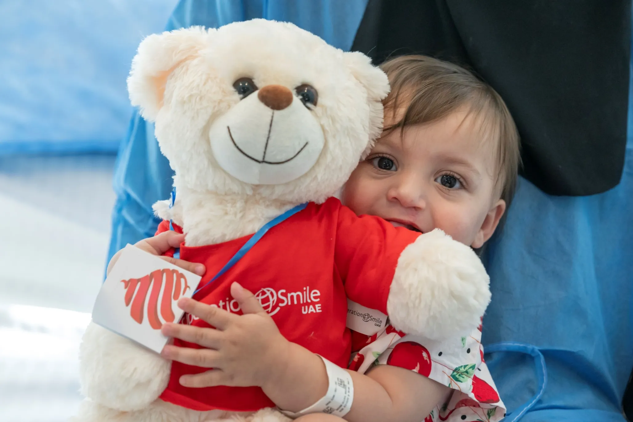 Marwa holds a teddy bear at Operation Smile UAE.