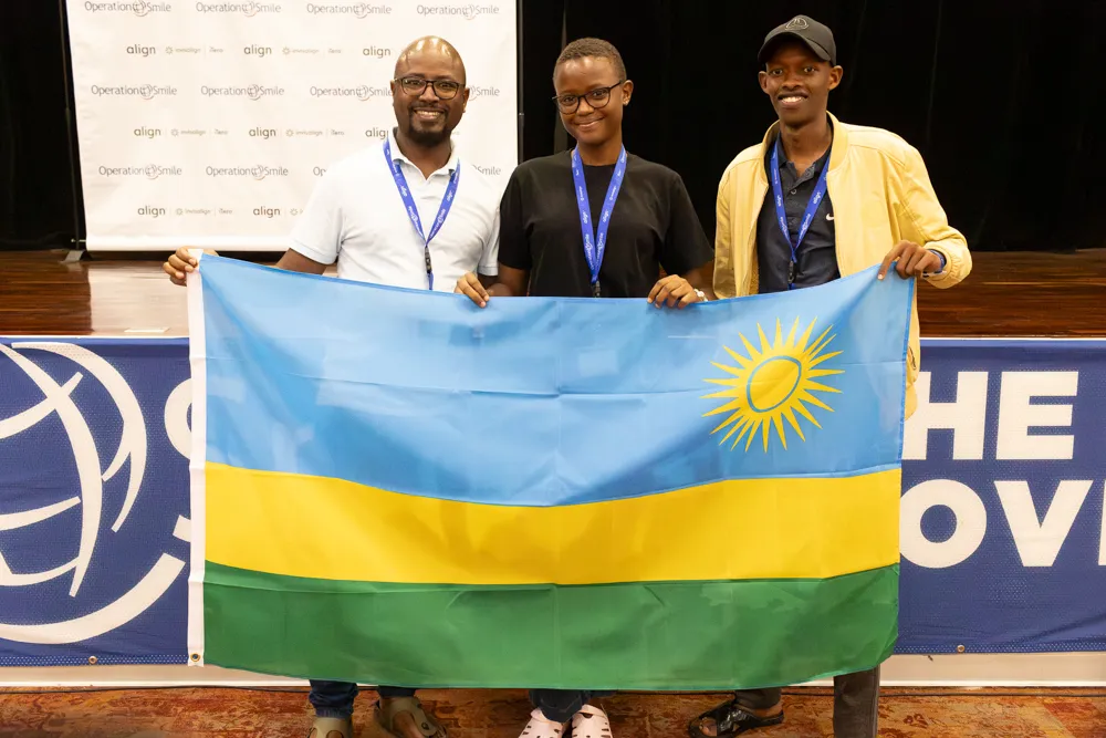 Students hold the flag of Rwanda during ISLC 2023.